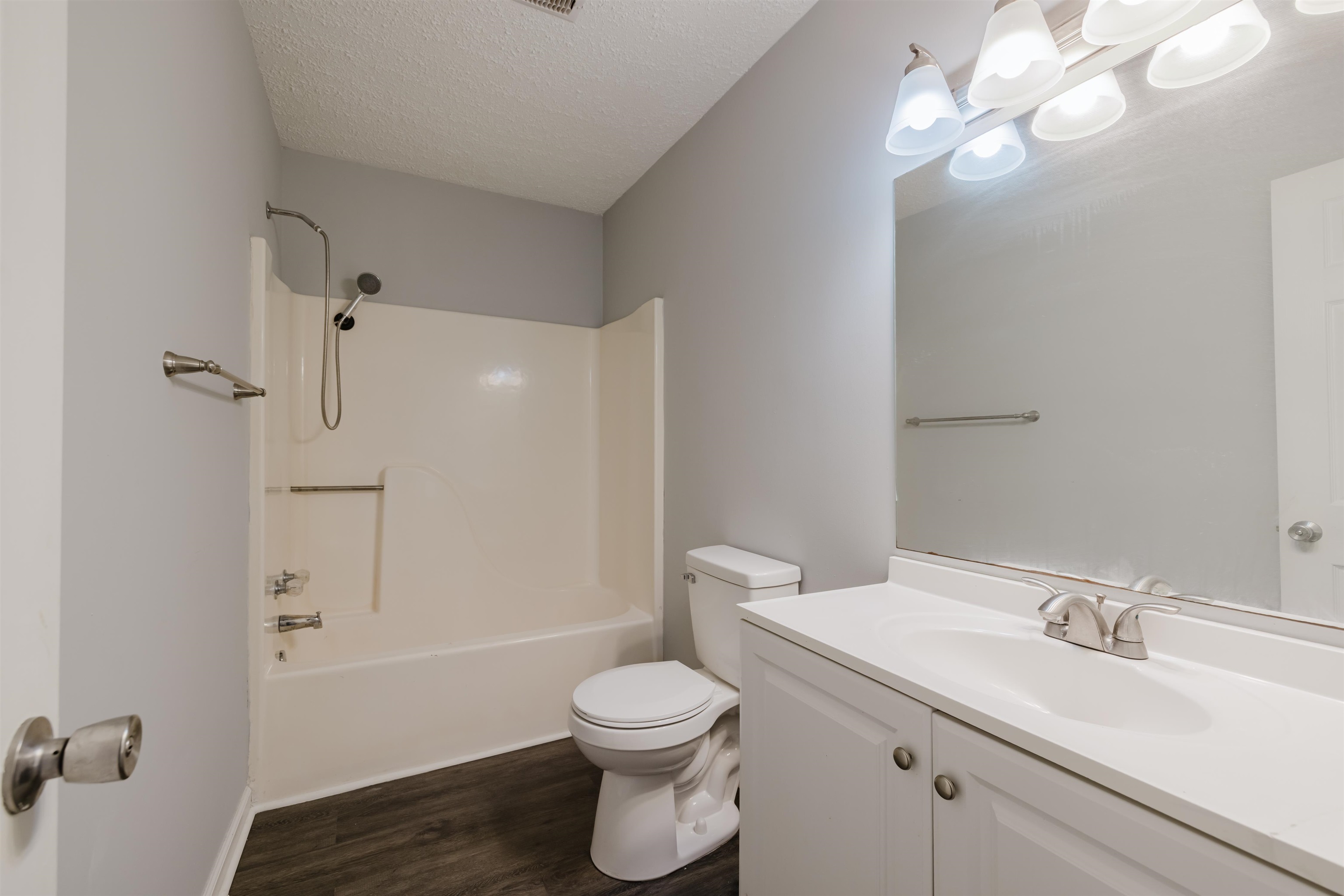 90 Freedom Way Myrtle Beach, SC 29577 - Photo 7 of 16 Bathroom featuring shower / bath combination, vanity, a textured ceiling, and dark wood finished floors