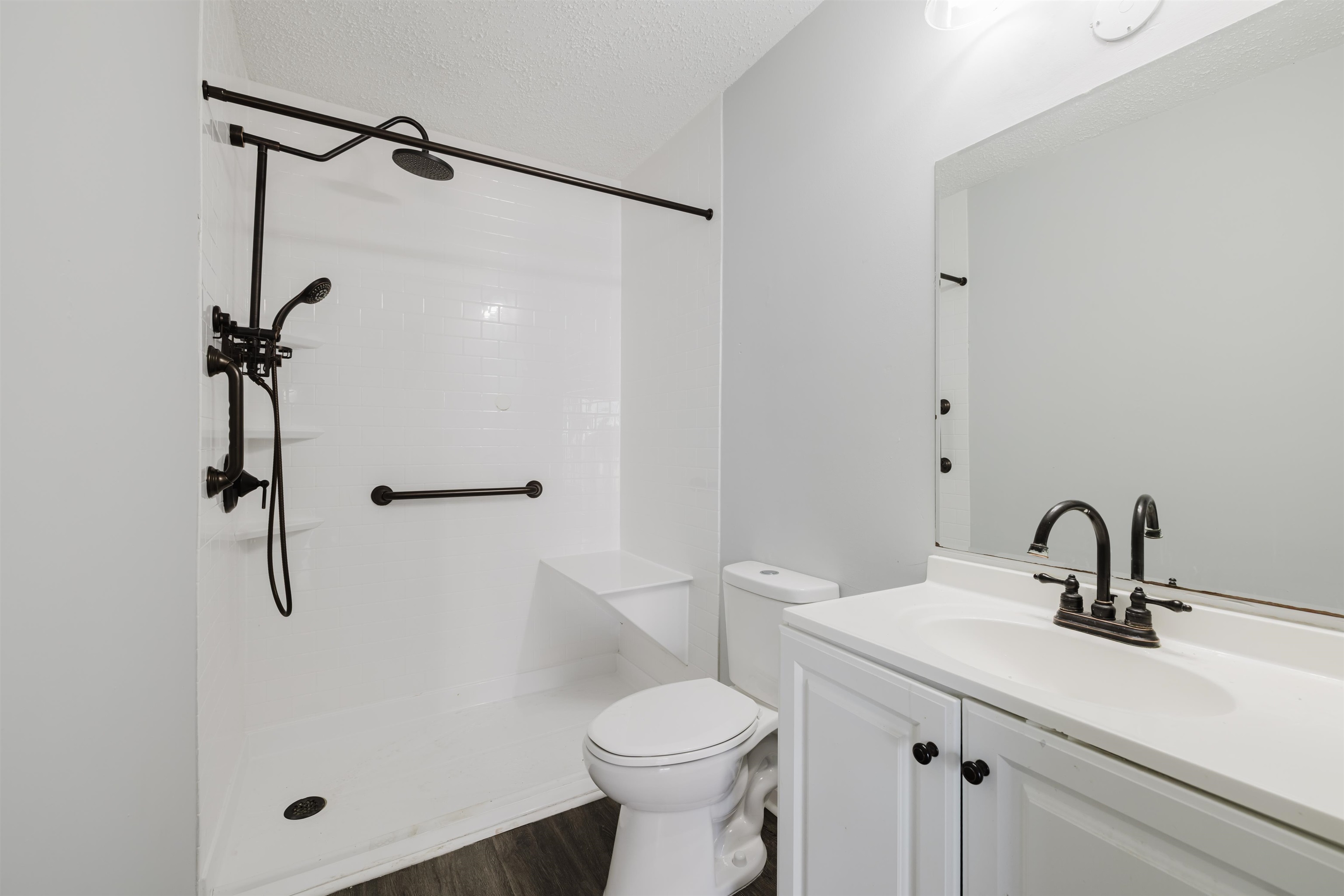 90 Freedom Way Myrtle Beach, SC 29577 - Photo 10 of 16 Full bathroom with vanity, walk in shower, a textured ceiling, and dark wood-style floors