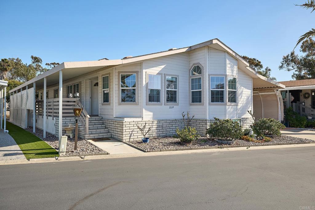 3339 Don Tomaso Drive Carlsbad, CA 92010 - Photo 1 of 38 a front view of a house with a garden and plants