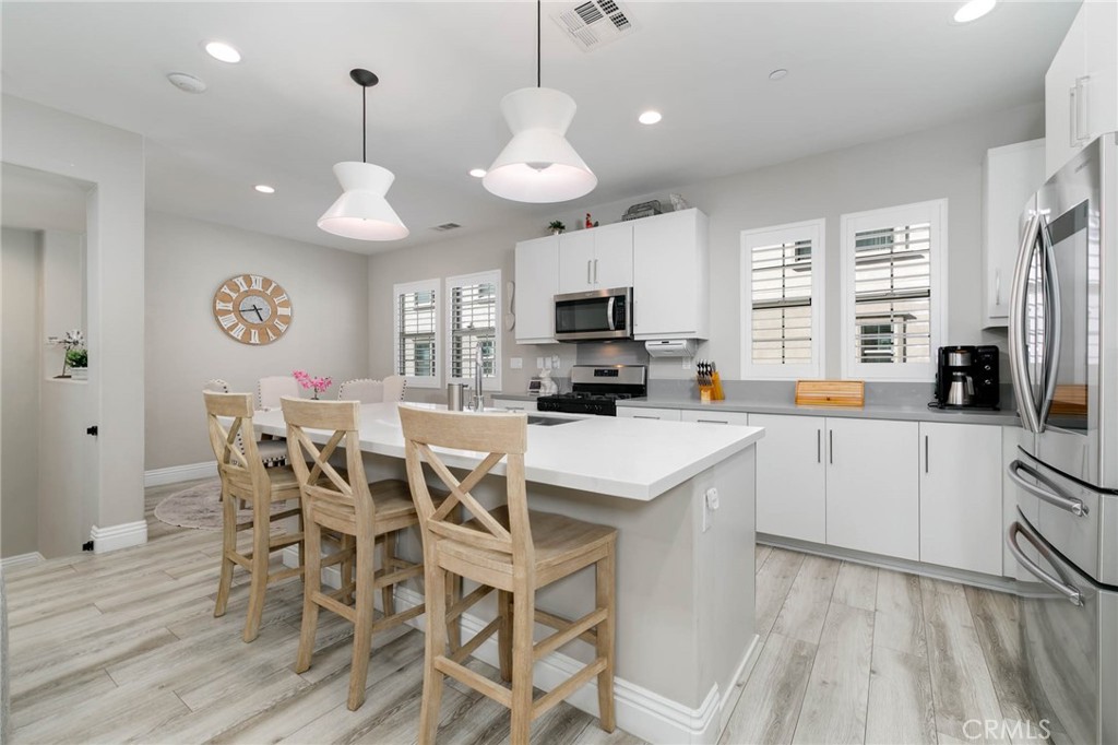a large kitchen with a table and chairs
