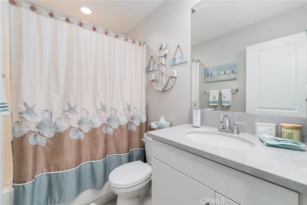 837 Iris Way, Unit C Azusa, CA 91702 - Photo 11 of 38 a bathroom with a granite countertop toilet sink and mirror