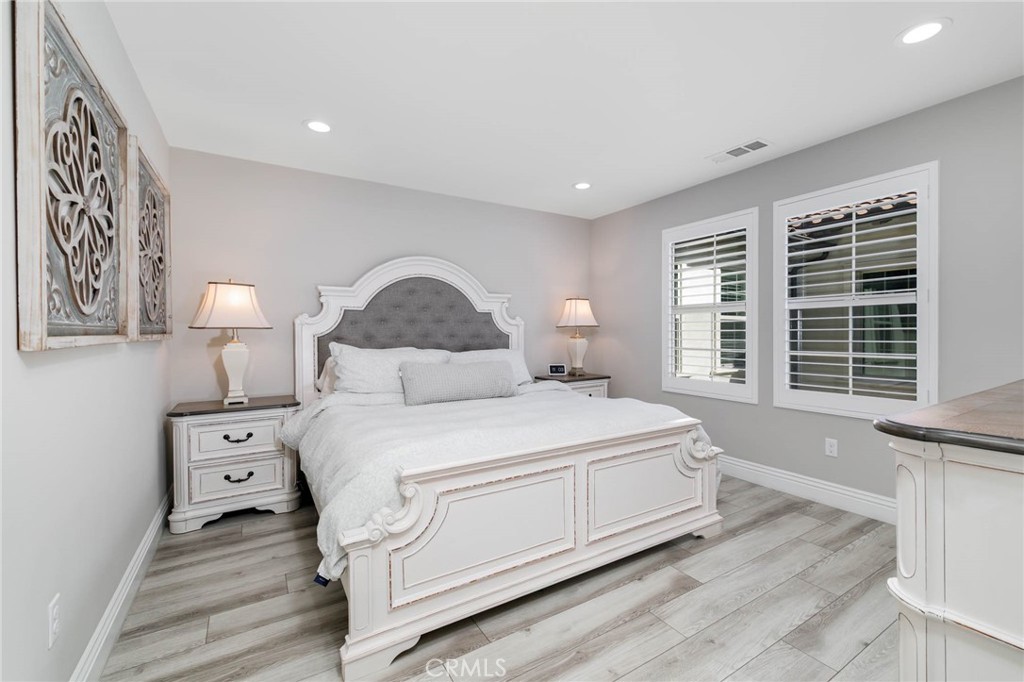 837 Iris Way, Unit C Azusa, CA 91702 - Photo 13 of 38 a bedroom with a bed and a large window