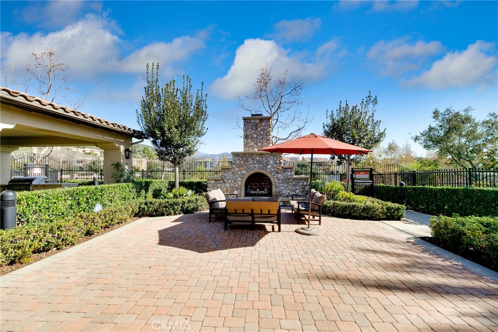 837 Iris Way, Unit C Azusa, CA 91702 - Photo 21 of 38 a view of a patio with a table and chairs under an umbrella