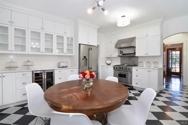 a bedroom with a large bed a chandelier and a window