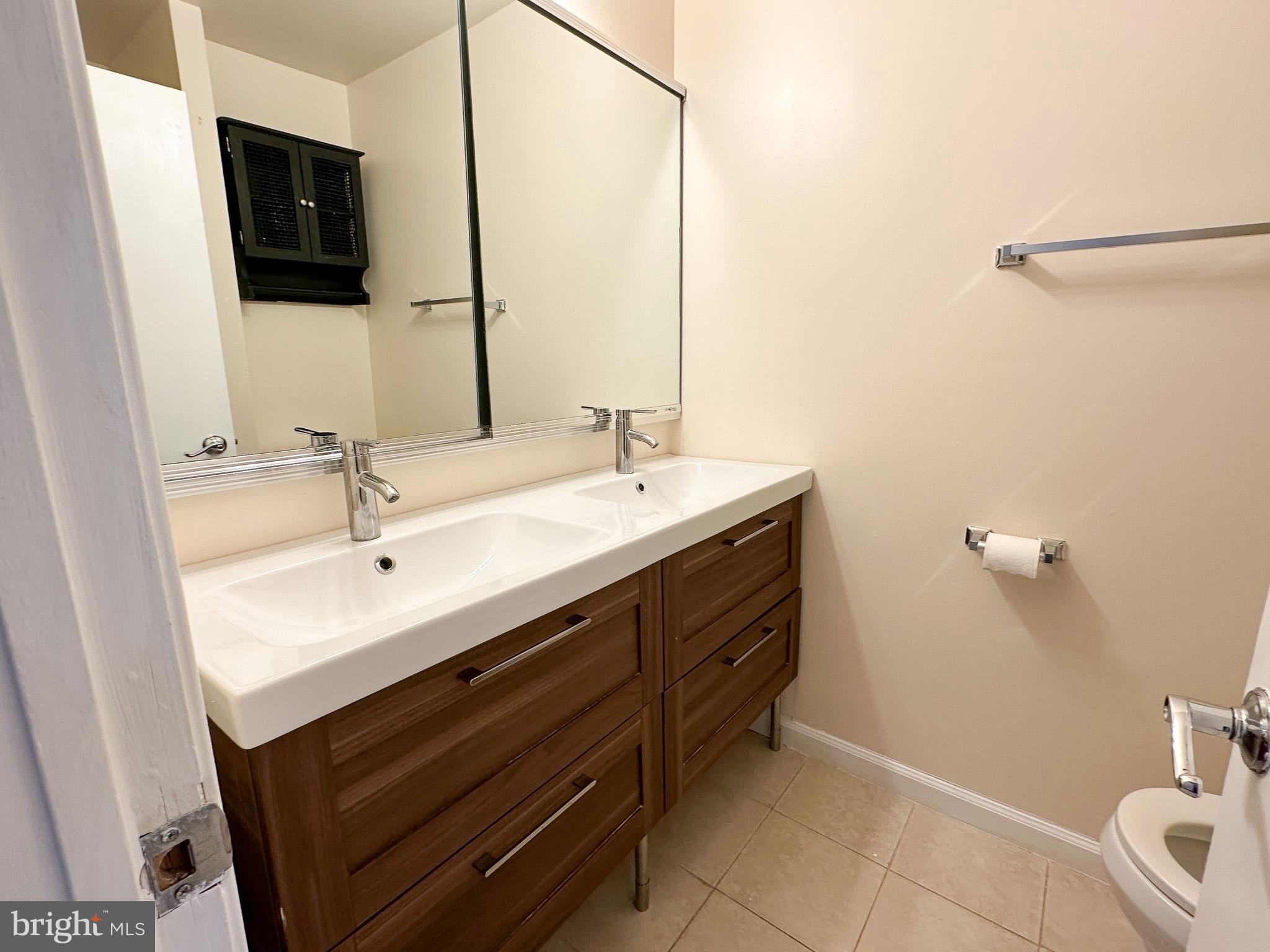 1803 Worthington Drive Exton, PA 19341 - Photo 16 of 27 a bathroom with a sink and a mirror