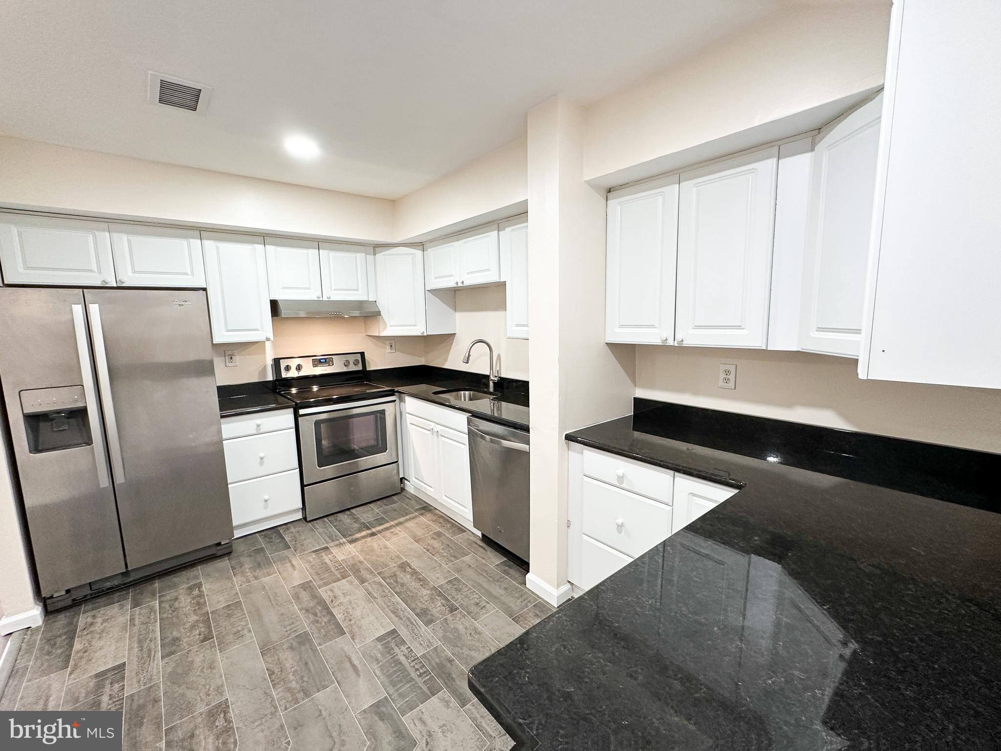 1803 Worthington Drive Exton, PA 19341 - Photo 4 of 27 a kitchen with granite countertop white cabinets and stainless steel appliances