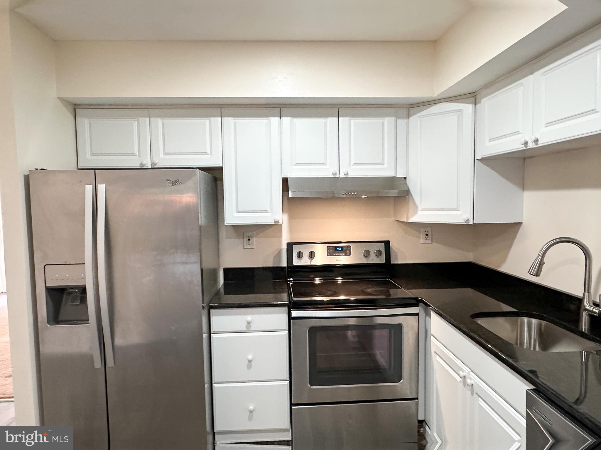 1803 Worthington Drive Exton, PA 19341 - Photo 5 of 27 a kitchen with a refrigerator stove and white cabinets