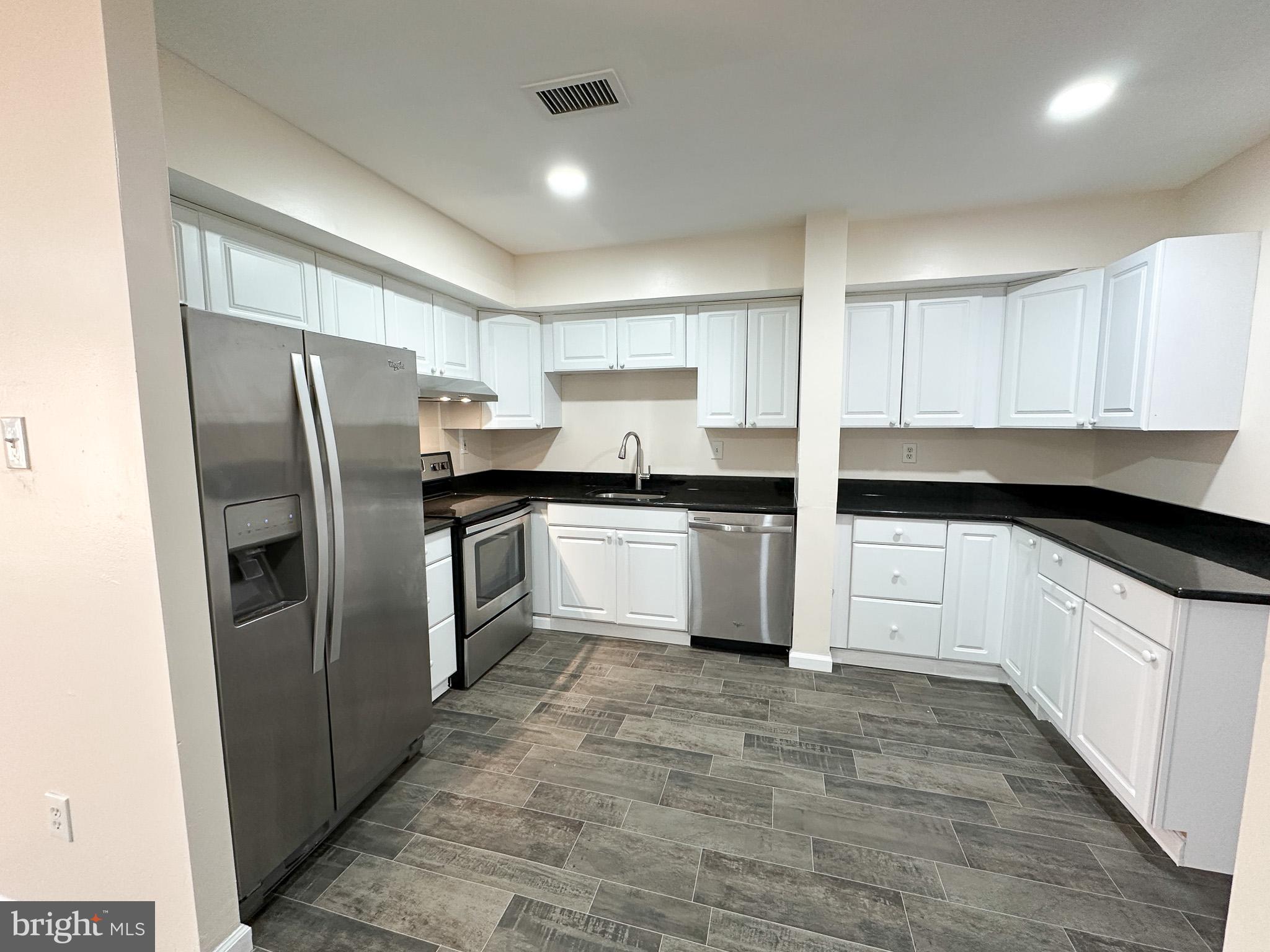 1803 Worthington Drive Exton, PA 19341 - Photo 7 of 27 a kitchen with granite countertop white cabinets and stainless steel appliances