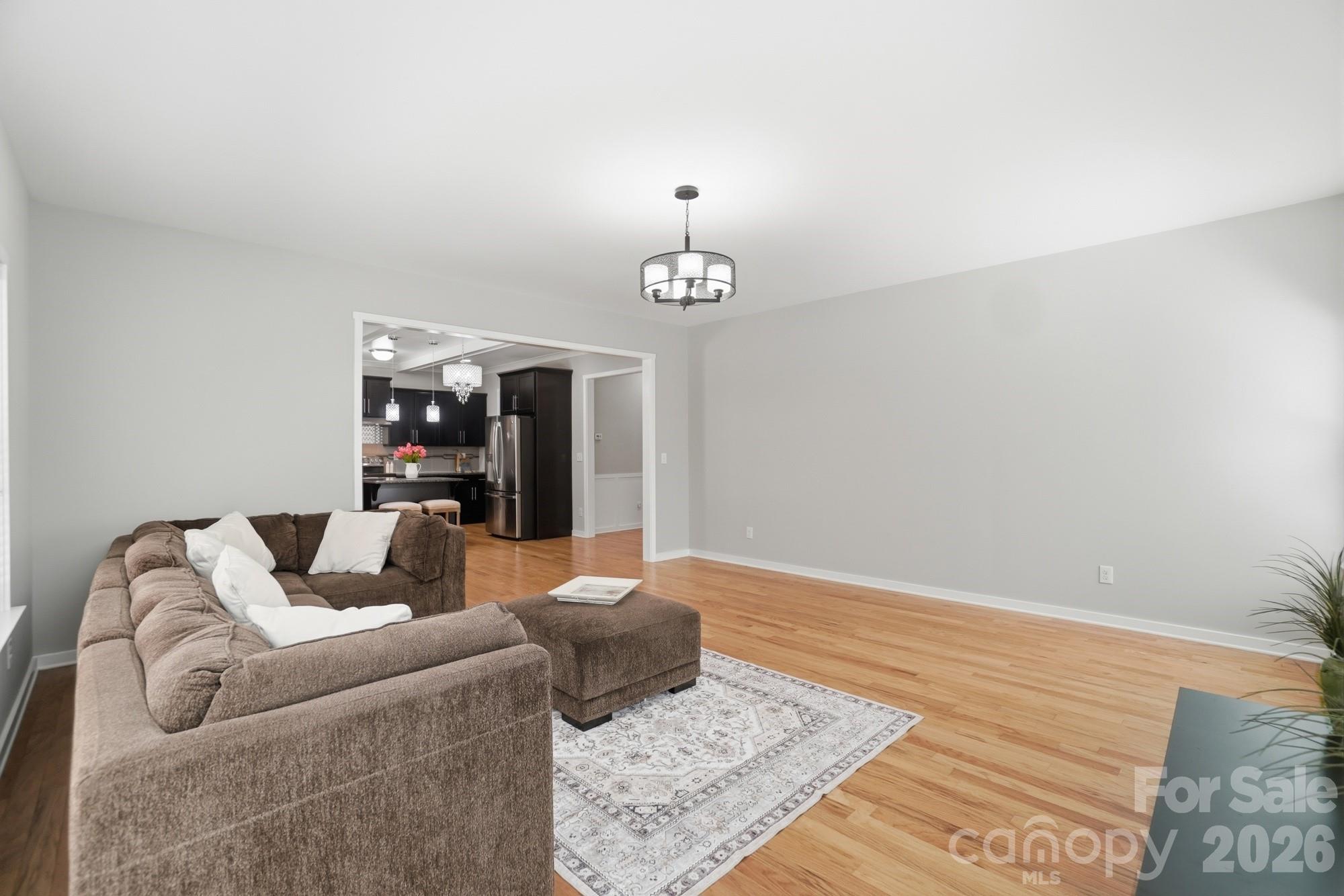 2153 Bluebell Way Tega Cay, SC 29708 - Photo 20 of 48 a living room with furniture and a chandelier