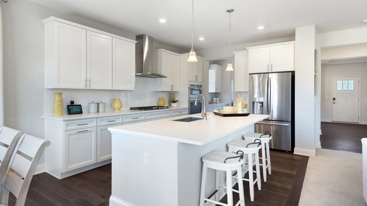 16151 Lake View Road Plainfield, IL 60586 - Photo 4 of 21 a kitchen with a refrigerator a white stove top oven a sink a dining table and chairs