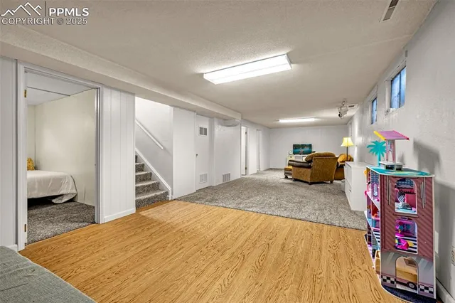 a bed sitting in a room next to a window