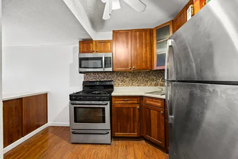 a kitchen with stainless steel appliances a stove a microwave and a refrigerator