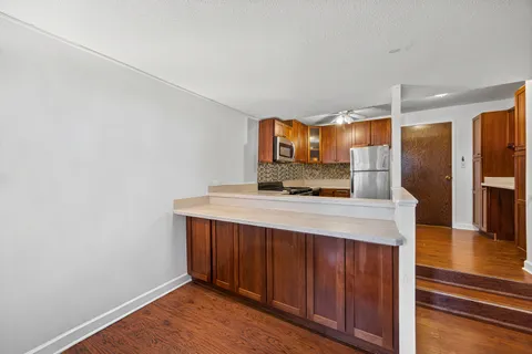 a kitchen with stainless steel appliances a sink and a refrigerator