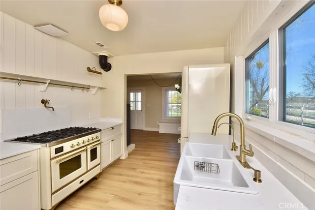 a kitchen with stainless steel appliances granite countertop a stove and a sink