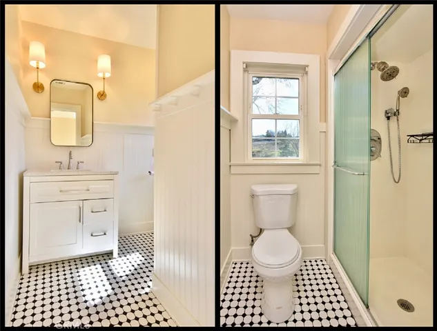 a bathroom with a sink a toilet a window and vanity