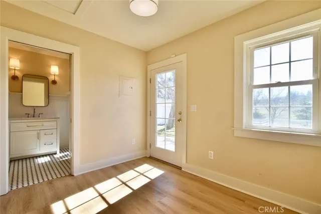 a view of a room with wooden floor and cabinet