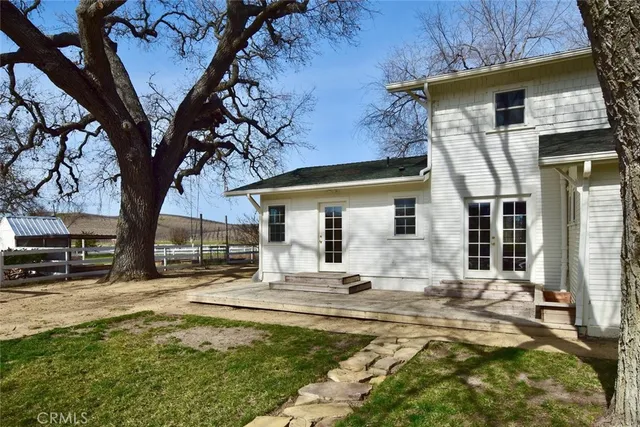 a view of a house with backyard porch and sitting area