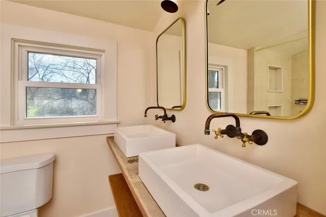 a bathroom with a tub a sink and a window