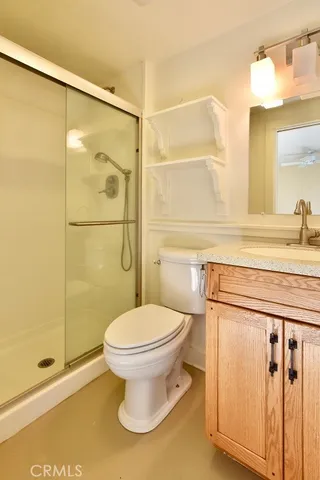 a bathroom with a shower a toilet and a sink