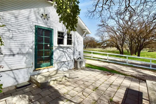 a view of a house with a large tree and a yard
