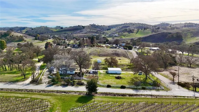 an aerial view of residential houses with outdoor space and river