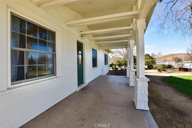 a view of a house with a yard and potted plants