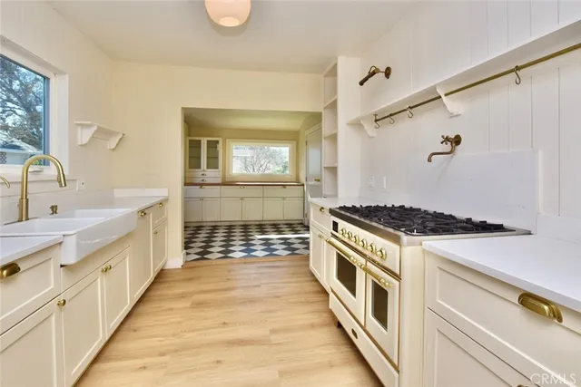 a kitchen with stainless steel appliances a stove and a sink