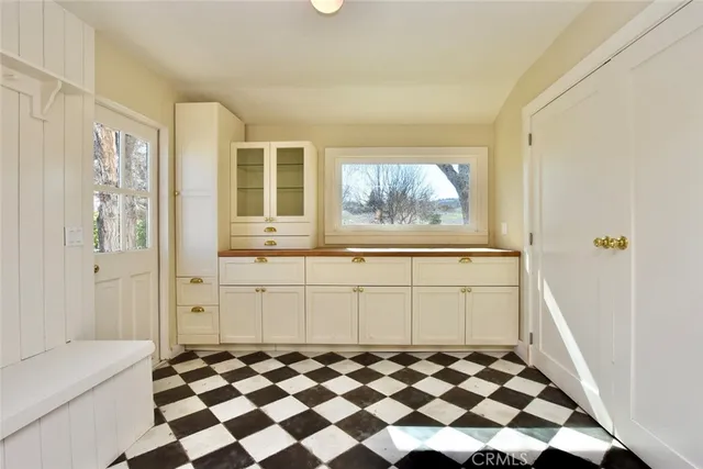 a view of a bedroom with wooden floor and cabinet