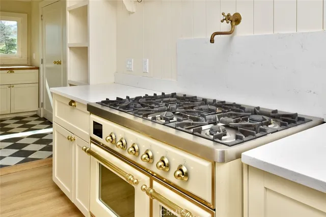 a stove top oven sitting inside of a kitchen