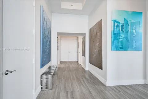 a bedroom with a bed and painting on the wall