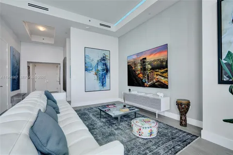 a bedroom with a bed and a television