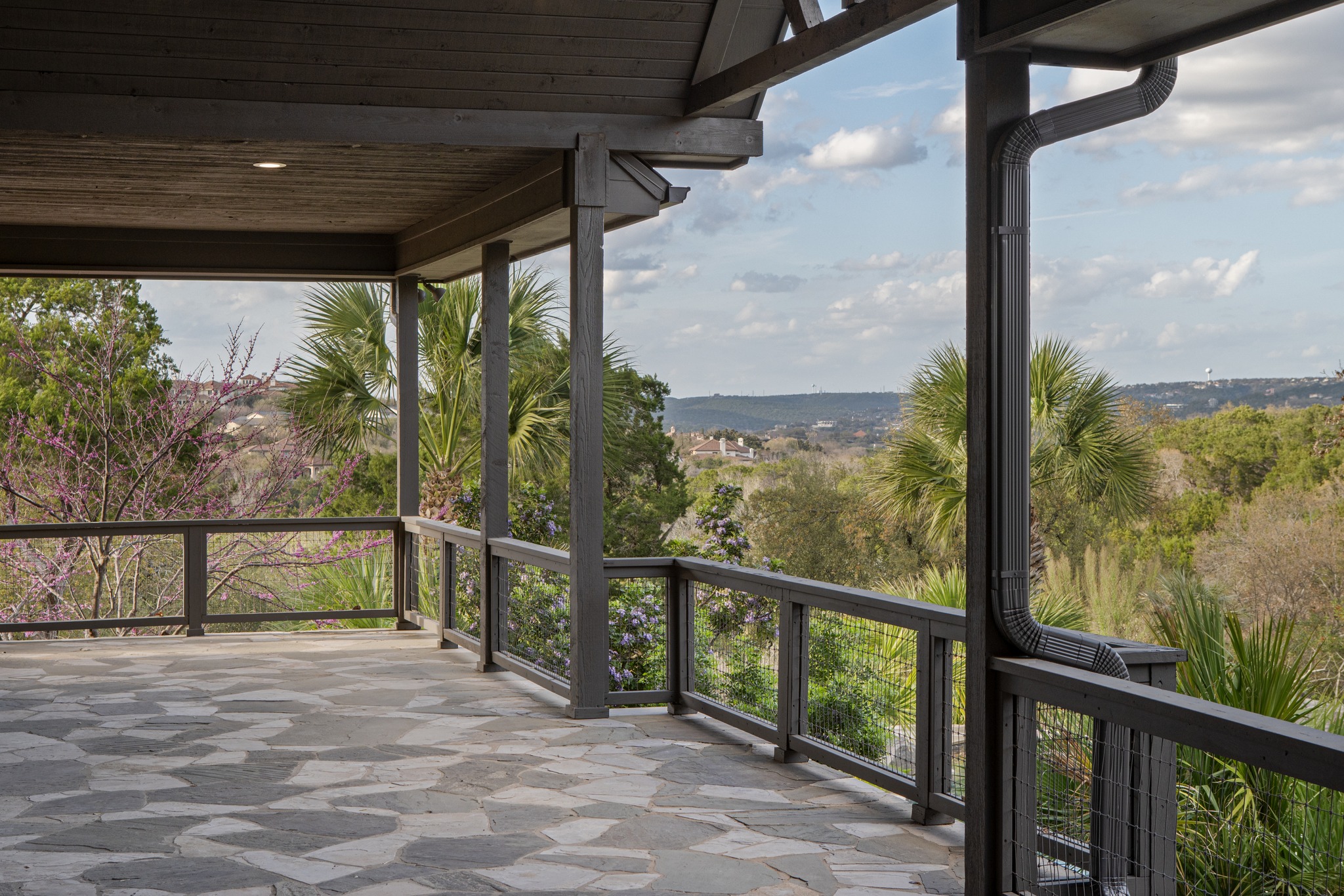 600 River Hills Road Austin, TX 78733 - Photo 23 of 40 Covered stone decking wraps around the back of the home