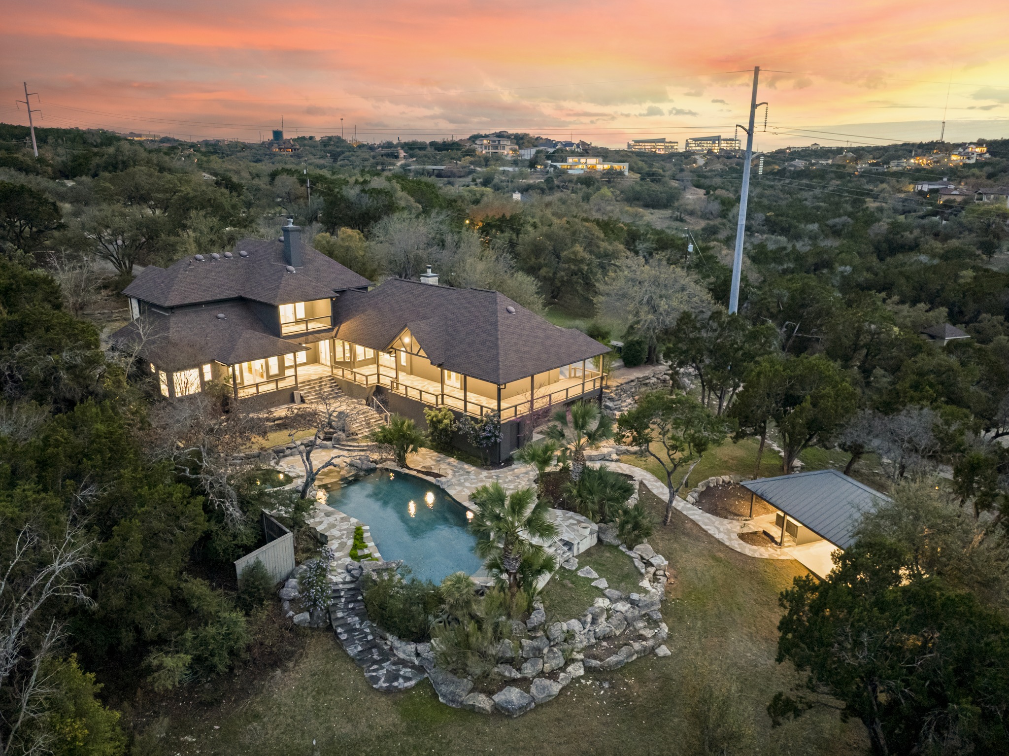 600 River Hills Road Austin, TX 78733 - Photo 25 of 40 Aerial view of pool and hill country at dusk