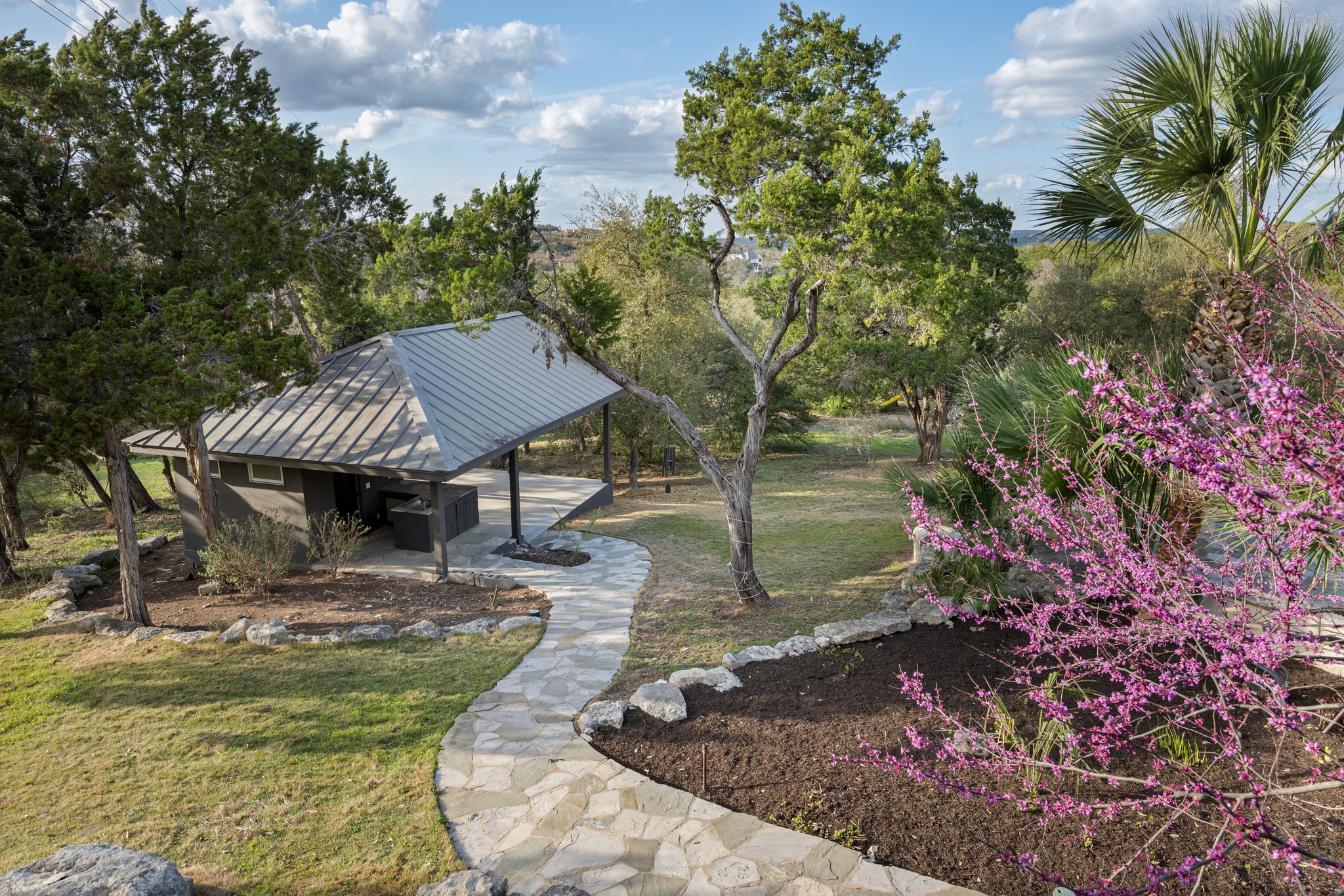 600 River Hills Road Austin, TX 78733 - Photo 32 of 40 Path to pool pavillion with bathroom, shower and outdoor kitchen