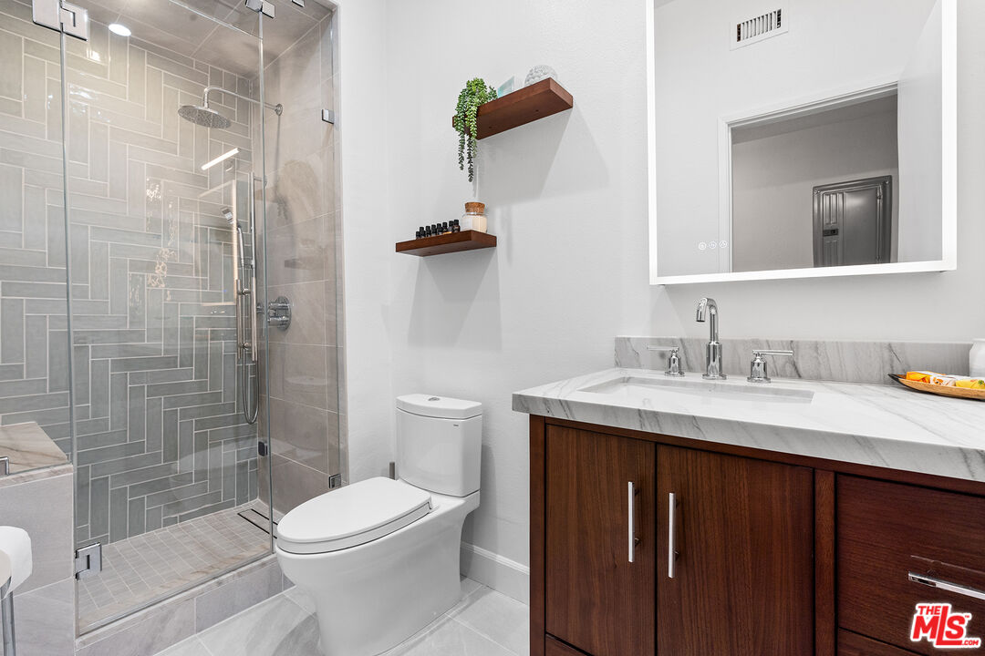 8160 Manitoba Street, Unit 101 Playa del Rey, CA 90293 - Photo 16 of 20 a bathroom with a sink toilet and shower