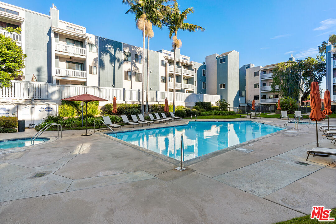 8160 Manitoba Street, Unit 101 Playa del Rey, CA 90293 - Photo 19 of 20 a view of a swimming pool with a lawn chairs and a fire pit