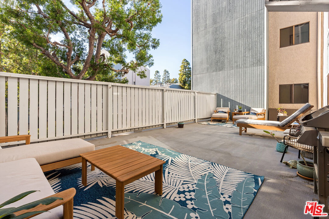 8160 Manitoba Street, Unit 101 Playa del Rey, CA 90293 - Photo 2 of 20 a backyard of a house with table and chairs