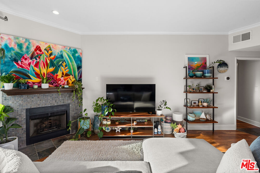 8160 Manitoba Street, Unit 101 Playa del Rey, CA 90293 - Photo 3 of 20 a living room with furniture fireplace and flat screen tv