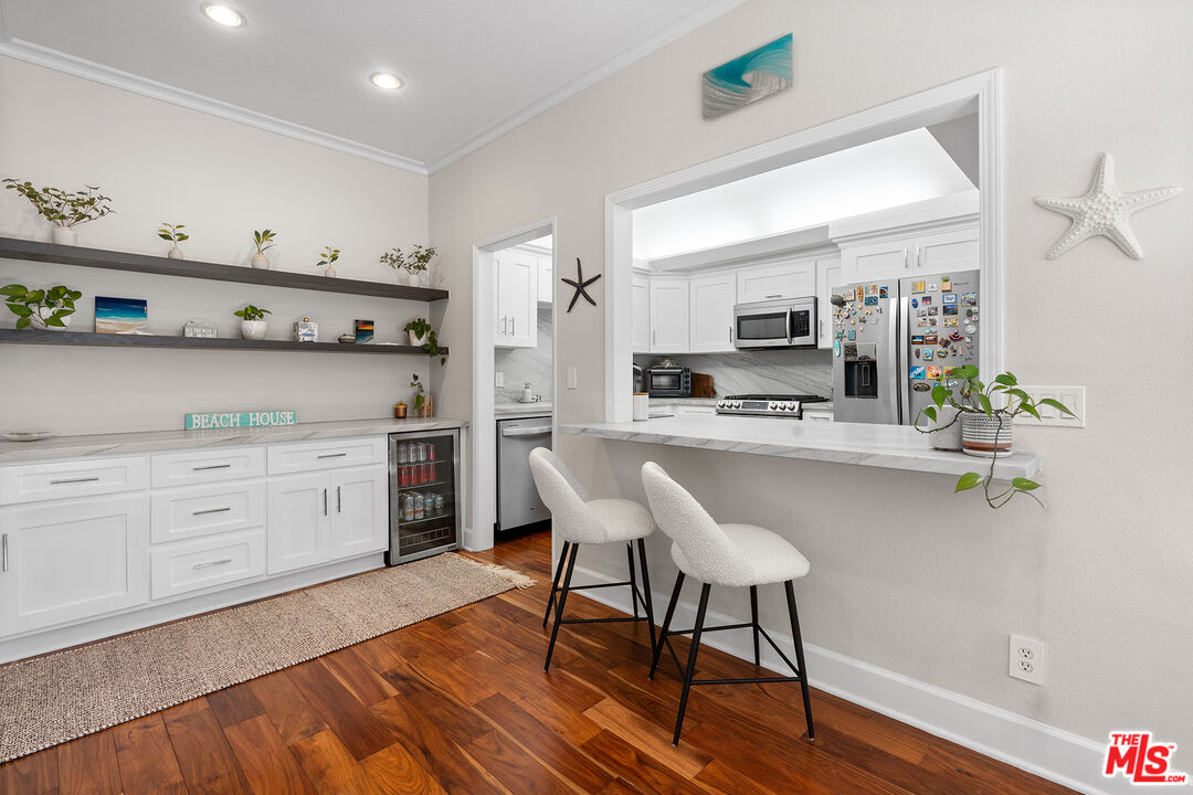 8160 Manitoba Street, Unit 101 Playa del Rey, CA 90293 - Photo 6 of 20 a kitchen with stainless steel appliances a stove a sink cabinets and wooden floor
