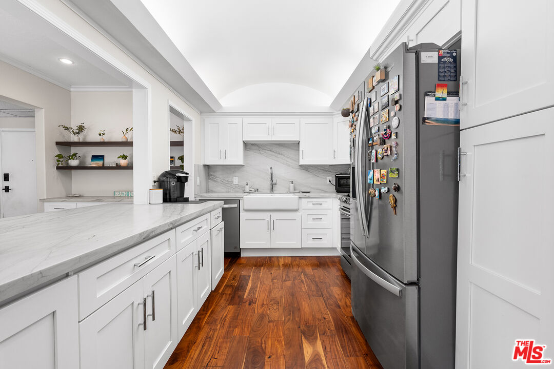 8160 Manitoba Street, Unit 101 Playa del Rey, CA 90293 - Photo 7 of 20 a kitchen with granite countertop a refrigerator and a sink