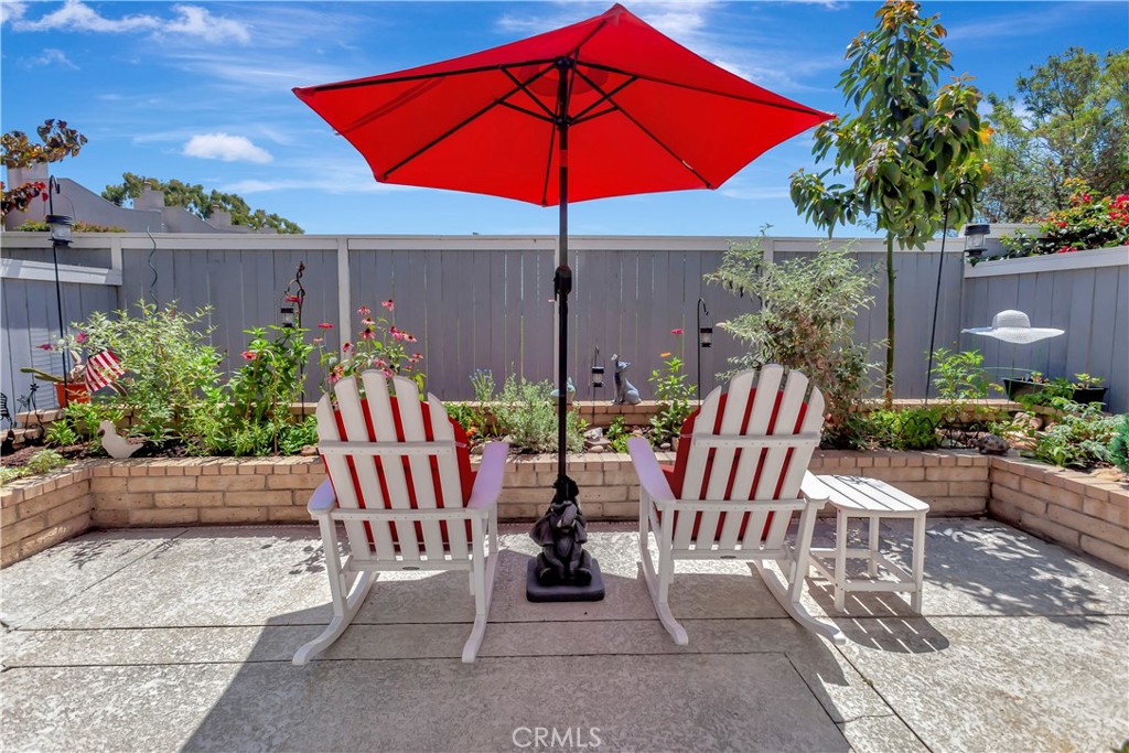 2523 Back Bay Loop, Unit 45 Costa Mesa, CA 92627 - Photo 24 of 26 Enjoy the patio retreat with custom planters filled with flowers, butterflies, and an avocado tree.