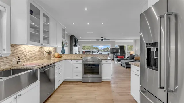 a kitchen with stainless steel appliances granite countertop a stove and a refrigerator
