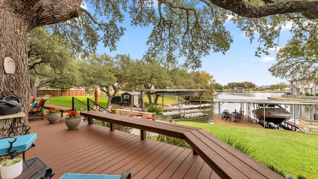 a view of a roof deck with couches and table under an umbrella