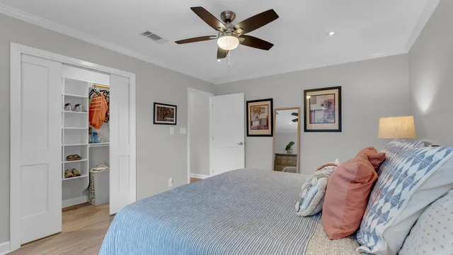a bedroom with a large bed and a chandelier