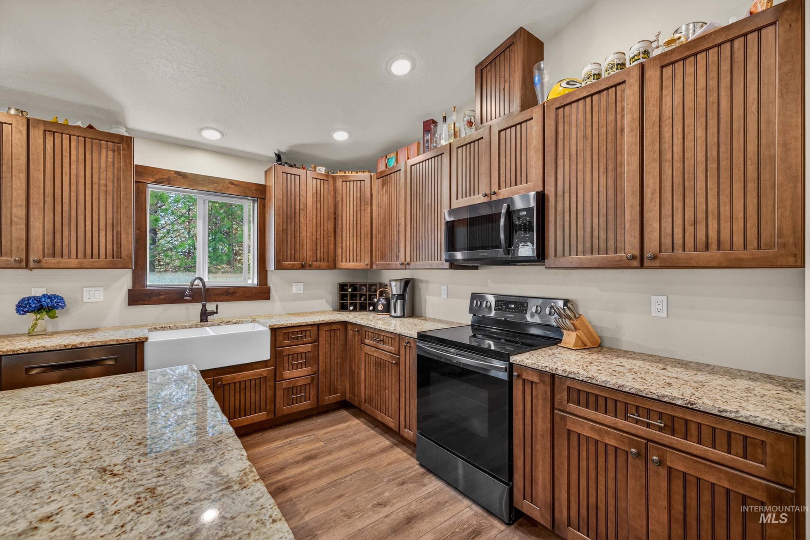 13388 Norwood Road McCall, ID 83638 - Photo 14 of 44 Kitchen featuring wood-finish cabinetry, granite countertops, and wood-finish flooring