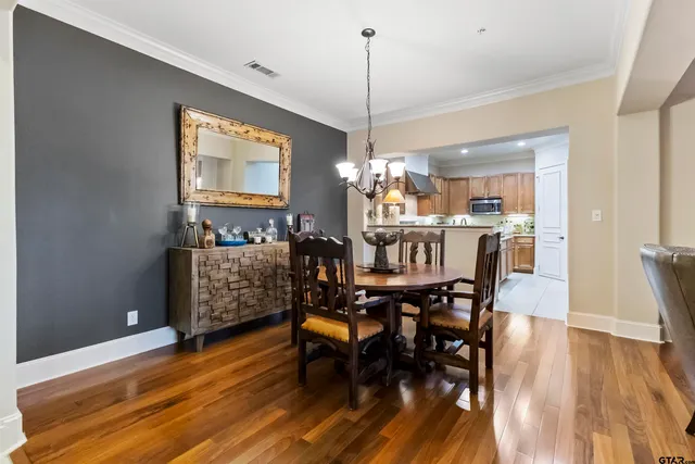 a kitchen with granite countertop kitchen island stainless steel appliances a sink a stove a refrigerator cabinets and a window