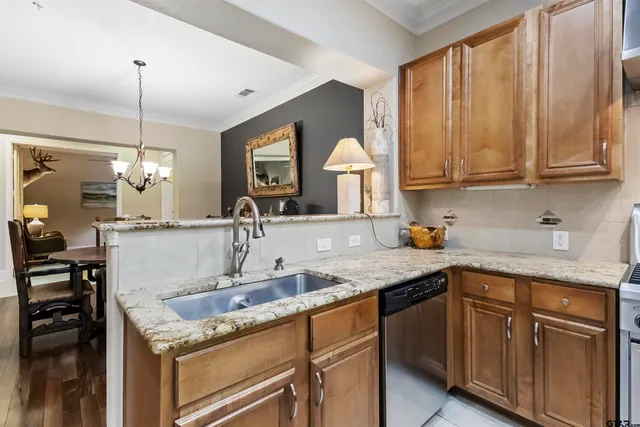 a kitchen with a stove a sink and a refrigerator