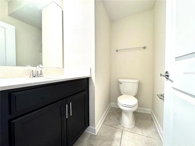 a bathroom with a sink toilet and a mirror