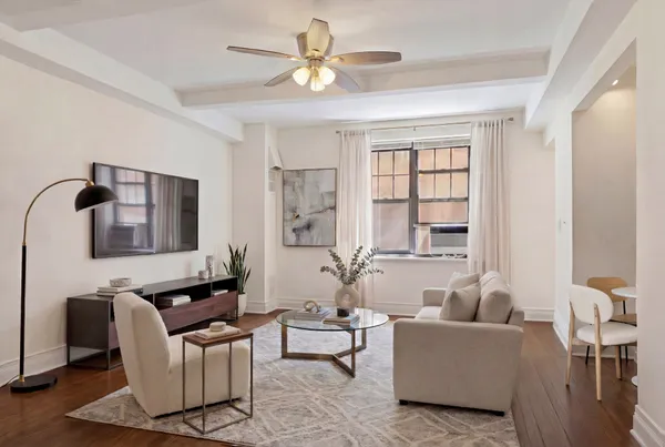 a living room with furniture and a large window