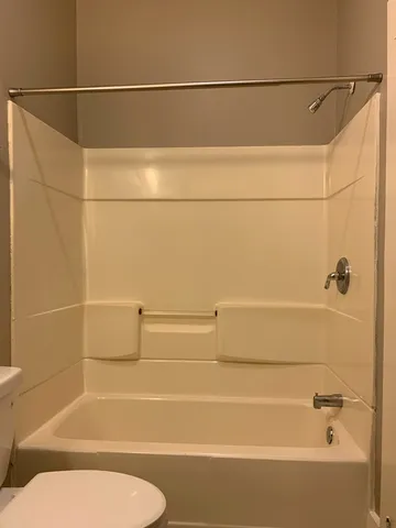 a utility room with red cabinets